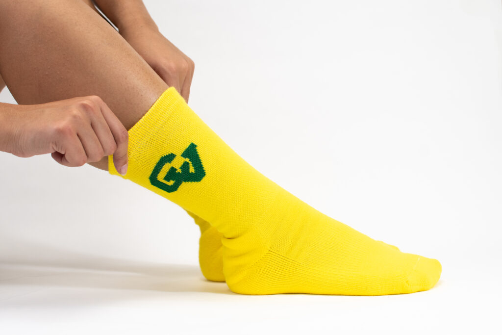 yellow custom socks with green college logo